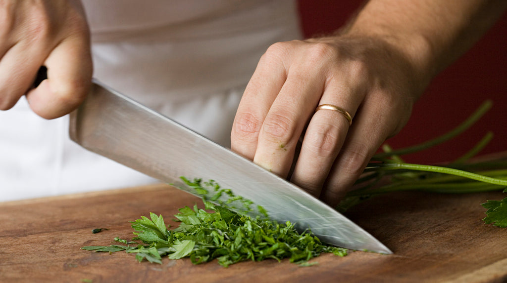 What Does Using a Blue Cutting Board Indicate in a Professional Kitchen?